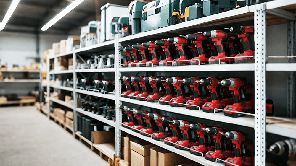 Rows of cordless power tools stored on warehouse shelves