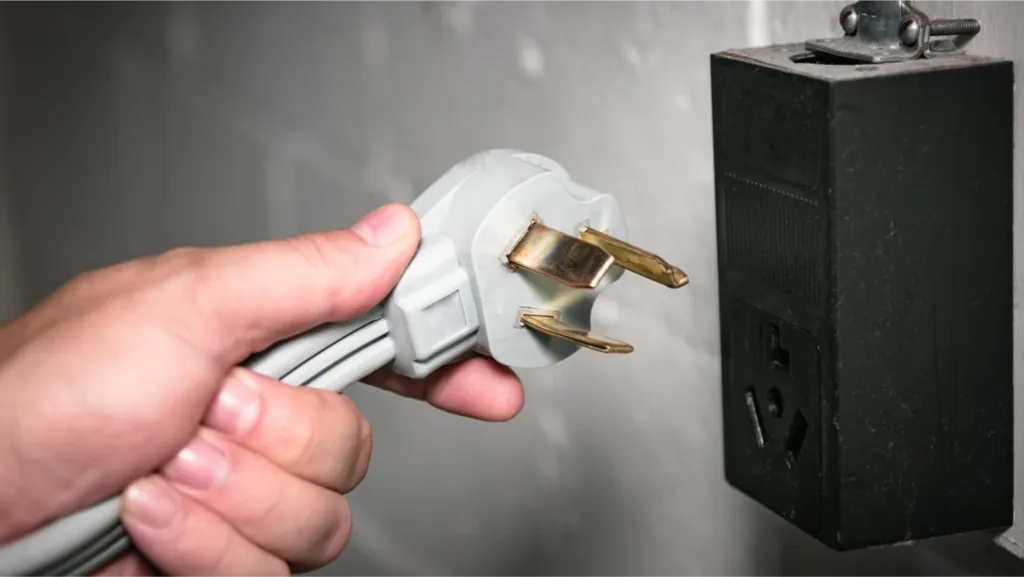 UK three-pin 240V plug beside a black power unit