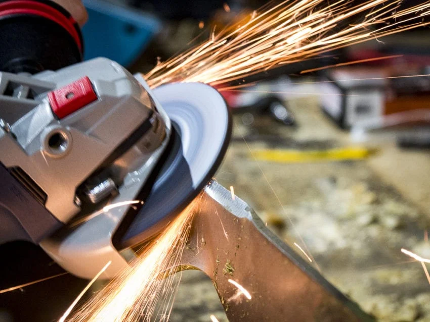 Angle grinder at a metal cutting workpiece