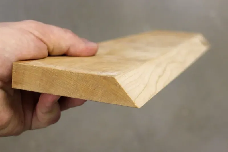 Wood board with a freshly cut beveled edge