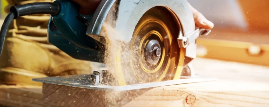Circular saw blade cutting through a wooden board