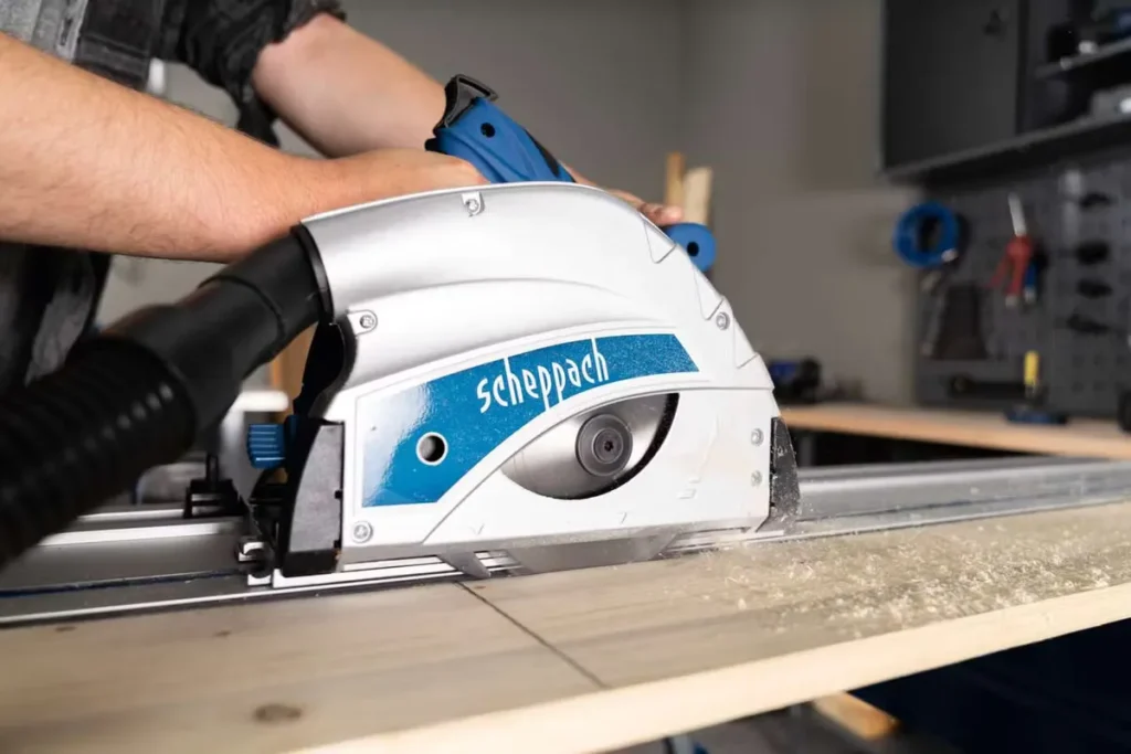 Corded plunge saw cutting along a guide rail