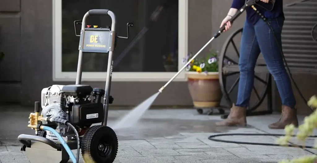 Cordless pressure washer cleaning a patio