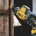 Cordless reciprocating saw cutting through wood