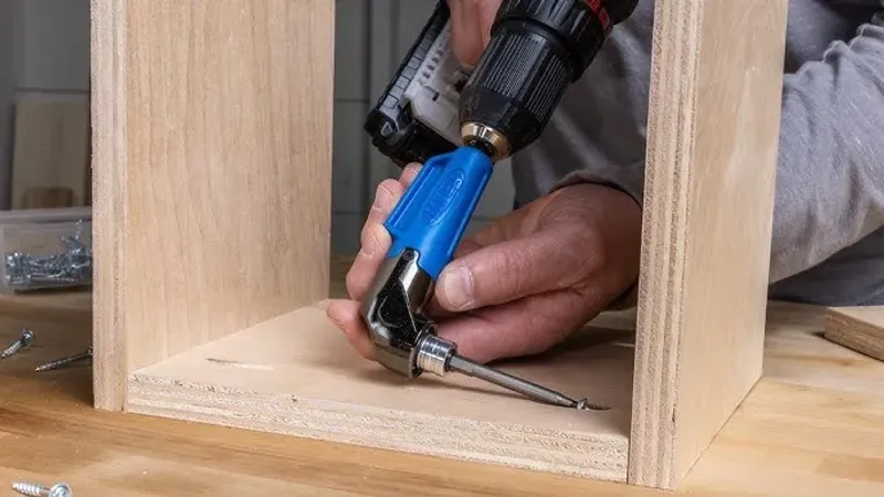 Electric screwdriver fastening a cabinet hinge
