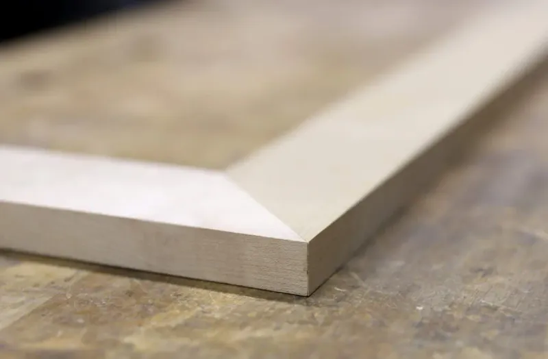 Close-up of a smooth bevel cut on a wooden board
