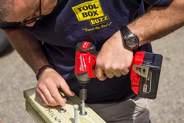 Impact driver fastening a screw into timber