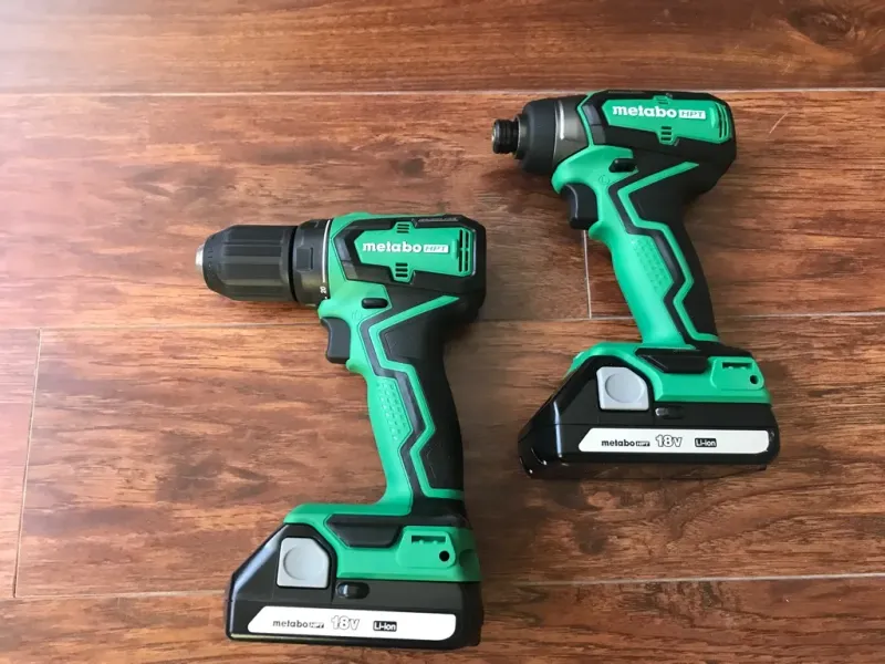 Impact driver and drill standing side by side