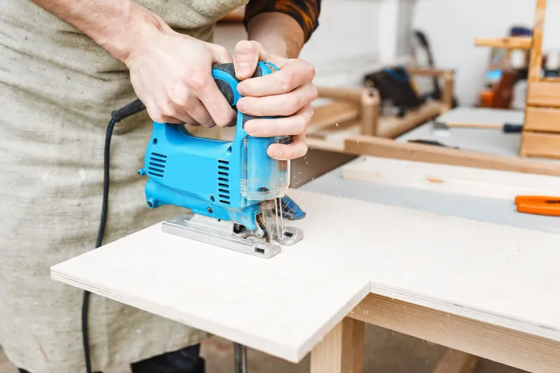 Jigsaw cutting a sheet of plywood
