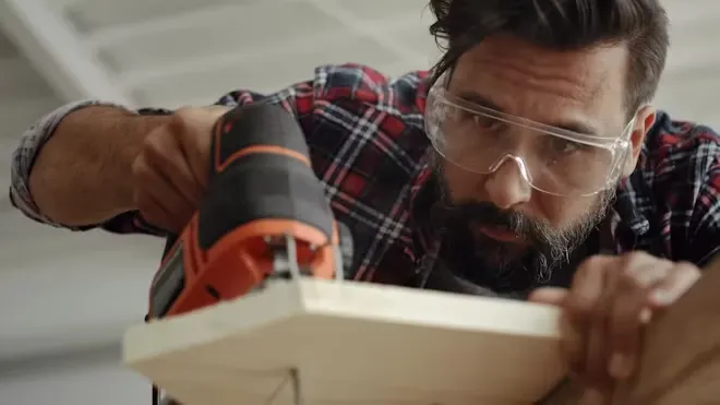 Close-up of a jigsaw cutting a wood board