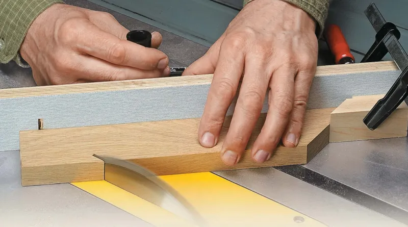Hands guiding wood through an angled miter cut