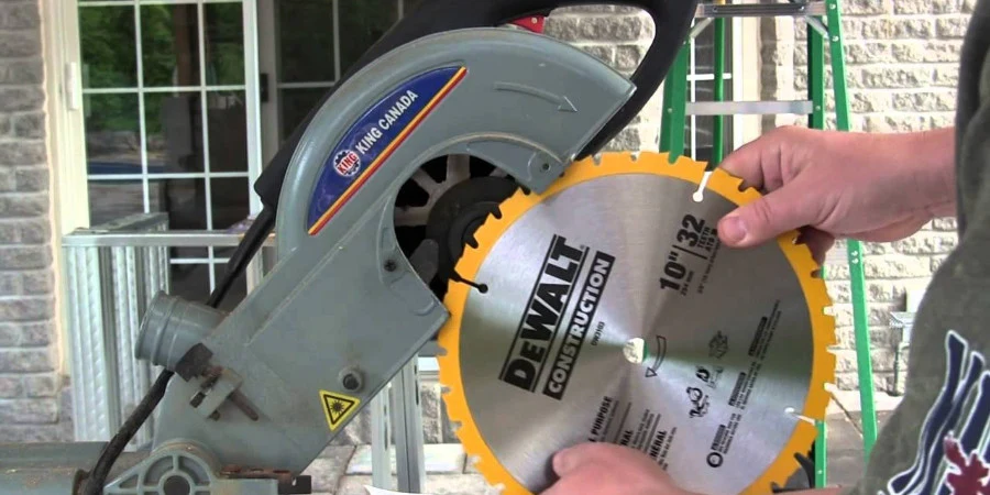 Person checking the blade size on a miter saw