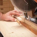 Miter saw making a straight crosscut in a wooden board