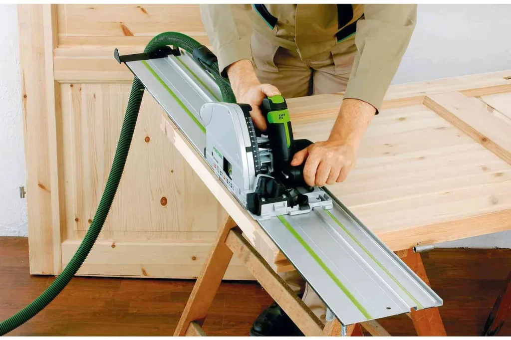 Plunge saw cutting plywood along a guide rail