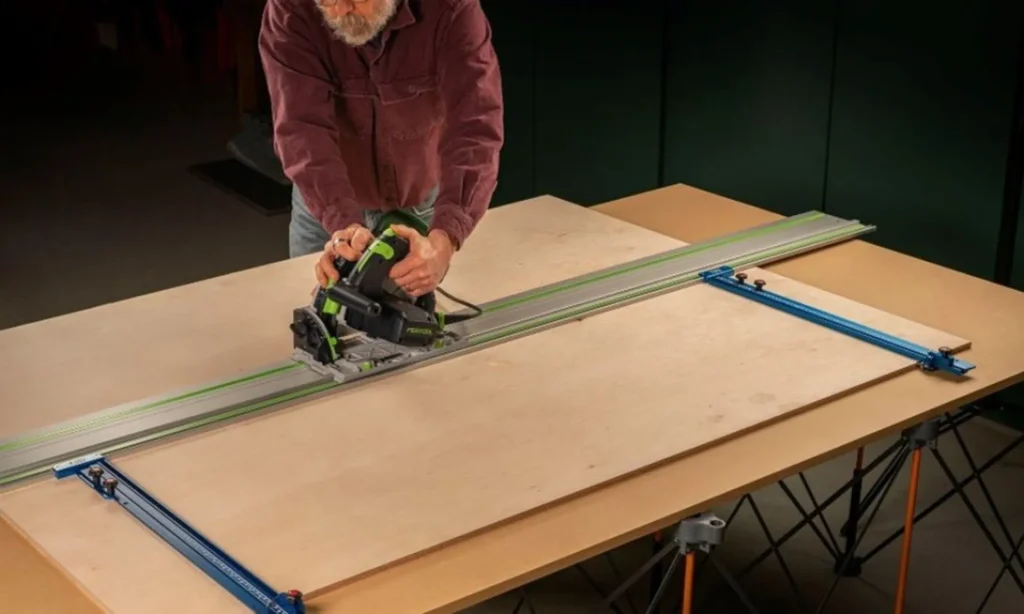 Plunge saw cutting a large wood sheet on guide rails
