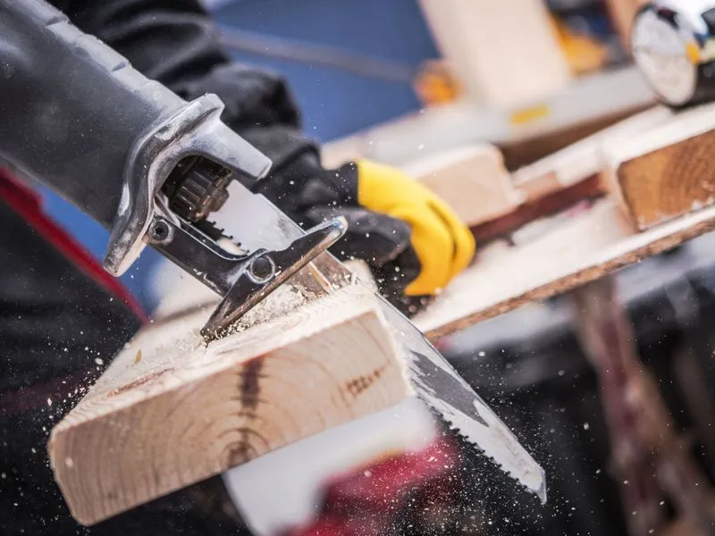 Reciprocating saw cutting a wood board