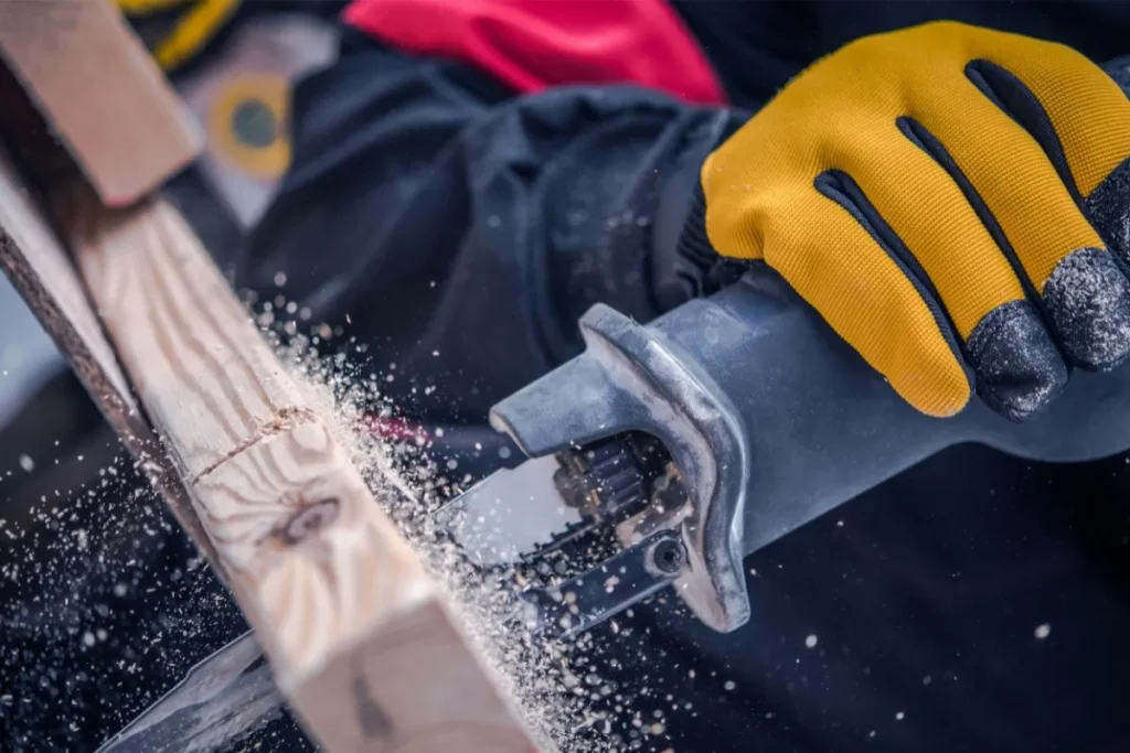 Worker holding a reciprocating saw for removal work