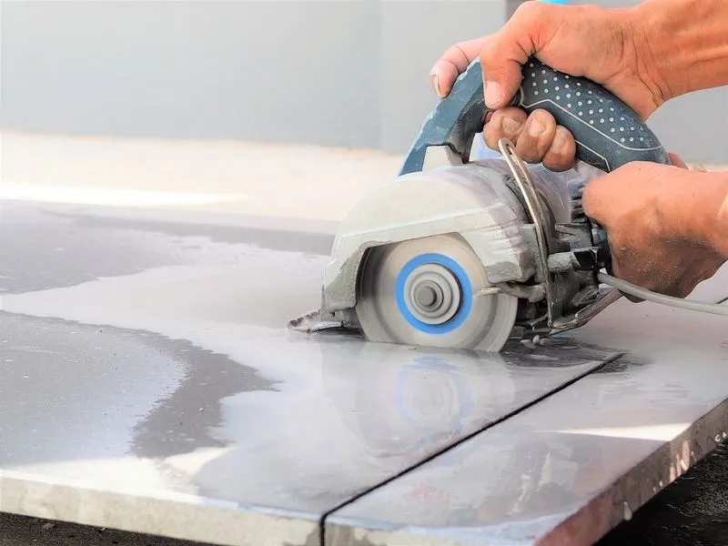 Purpose-built wet tile saw cutting a slab